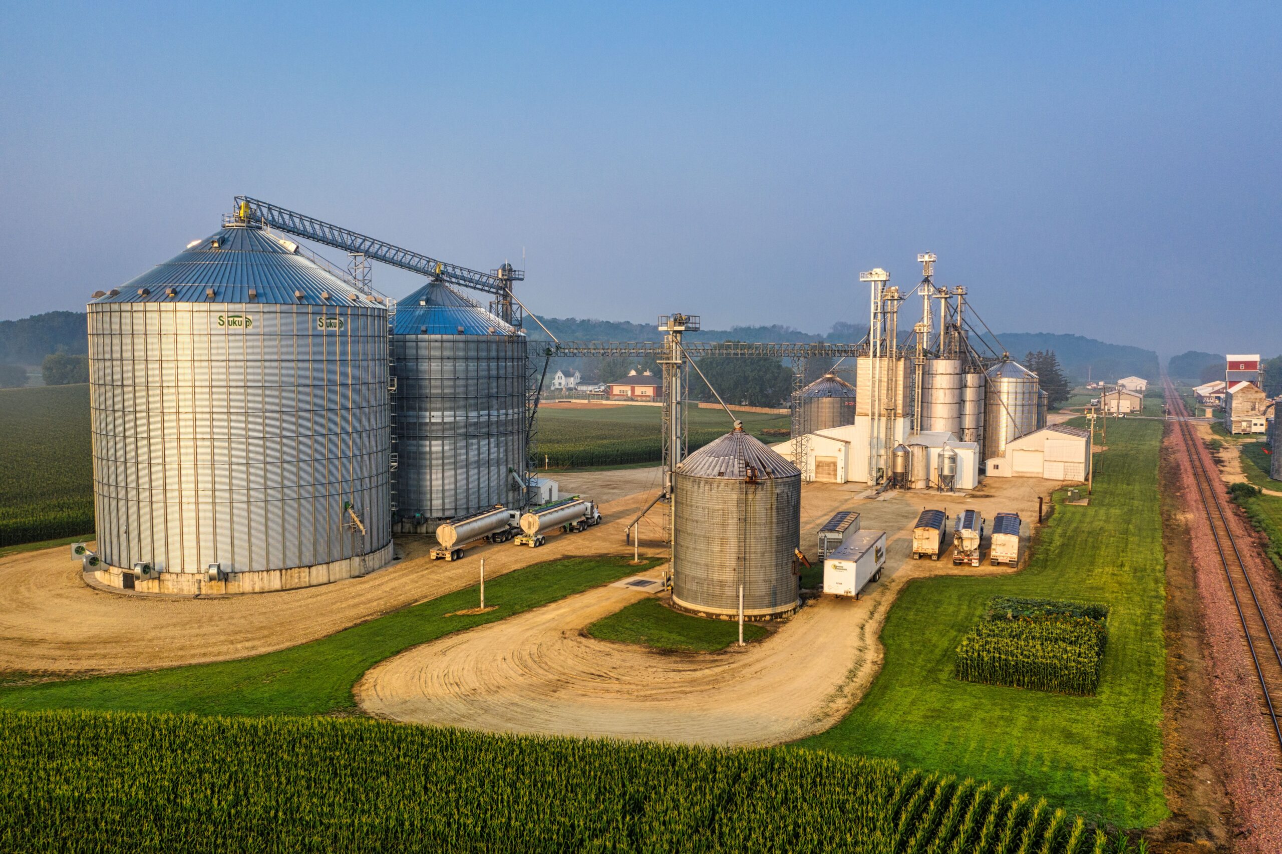 Industrial silos and grain storage facilities at sunrise in Utica, Minnesota.